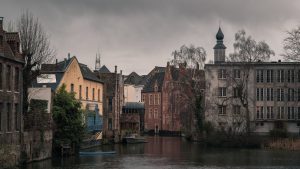 Atmospheric view of a historic canal and old town architecture in Ghent, Belgium.